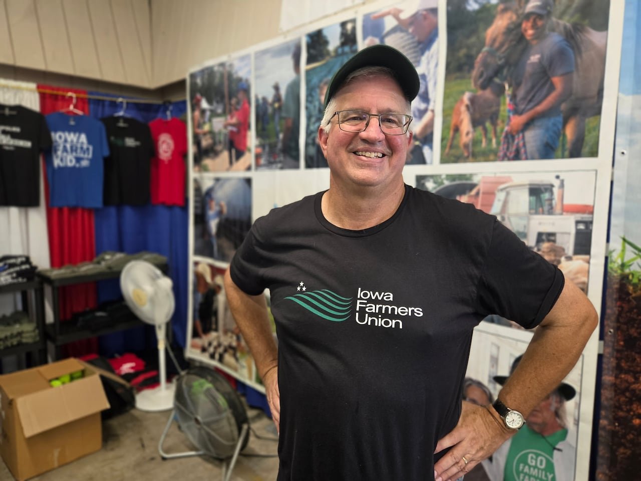 A man wearing a cap and black shirt